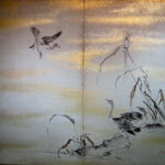Two hold paper screen painted in ink  on a gold ground with reed and goose