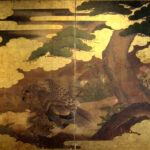 two hold paper screen painted in ink and color on a gold ground with pine tree and hawk